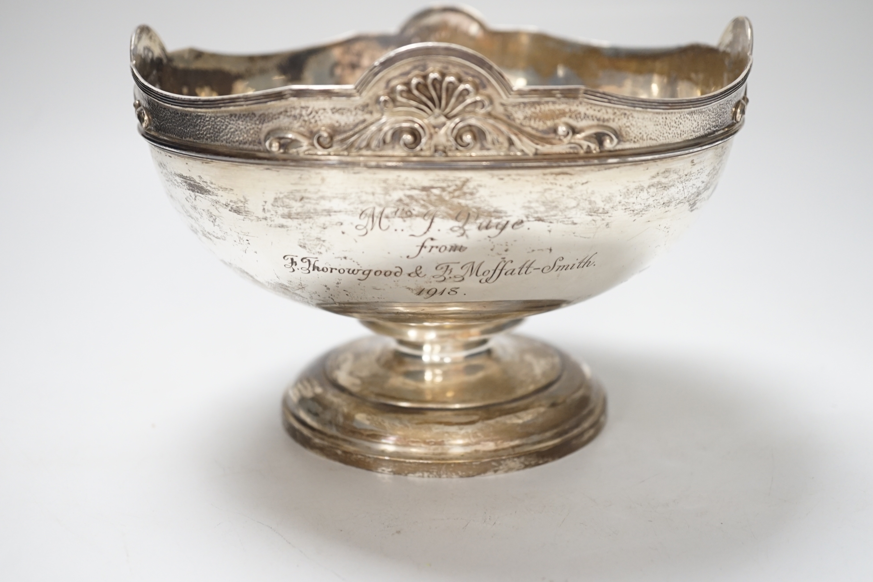 A George V silver rose bowl, with anthemion and scroll decorated rim, and 1918 presentation inscription, makers Garrard & Co., London 1913, diameter 18.5cm, 601 grams